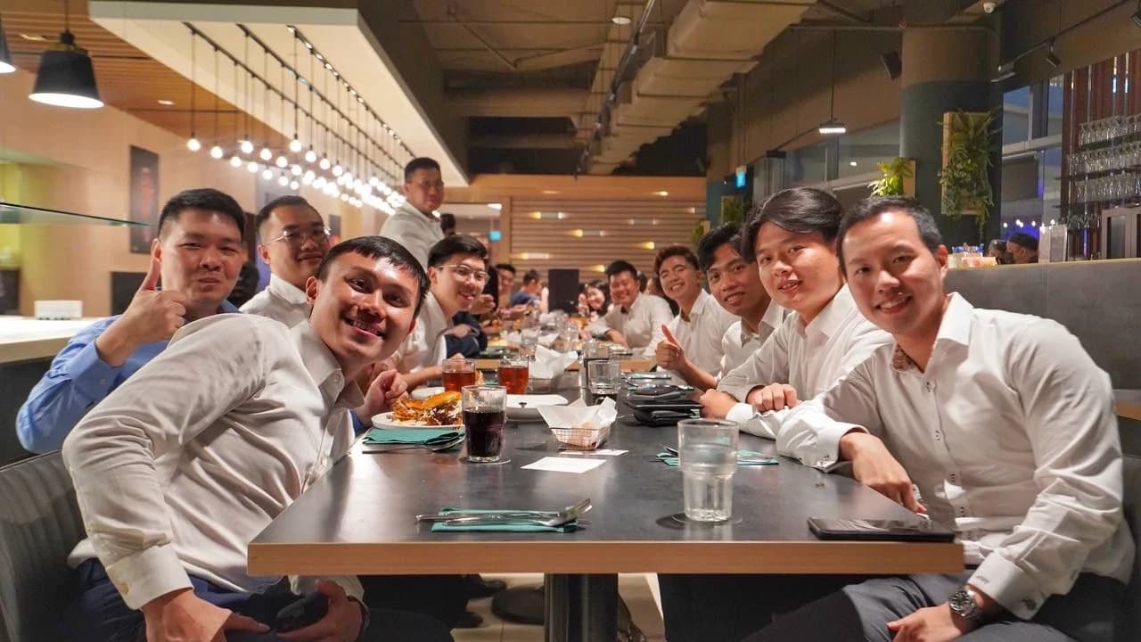 Guests smiling around a long dining table at Earle Swensen’s